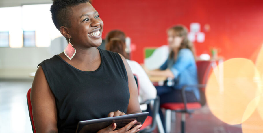 Confident female designer working on a digital tablet in red